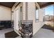 The front door displays a modern design with stone details, enhancing the property's curb appeal at 10512 Truckee St, Commerce City, CO 80022