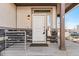 Close-up of the home's front door with stone accents and a modern light fixture at 10512 Truckee St, Commerce City, CO 80022