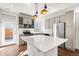 Kitchen with stainless steel appliances, stone backsplash, and center island at 10512 Truckee St, Commerce City, CO 80022