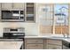 Kitchen featuring a stainless steel appliances and a tiled backsplash at 10512 Truckee St, Commerce City, CO 80022