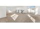 Open loft space with plush carpet, white walls, natural light, and black and white railing at 10512 Truckee St, Commerce City, CO 80022