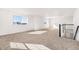 Sun-filled loft area with soft carpeting, large windows, and modern black and white railing at 10512 Truckee St, Commerce City, CO 80022