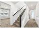 Carpeted staircase with modern railing and natural light from adjacent room at 10512 Truckee St, Commerce City, CO 80022