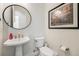 Clean bathroom features a pedestal sink, modern fixtures, and neutral wall art at 7169 Canyon Sky Trl, Castle Pines, CO 80108
