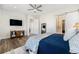 A primary bedroom showing hardwood floors, a ceiling fan, and a sliding door to a bathroom at 7169 Canyon Sky Trl, Castle Pines, CO 80108