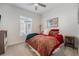 Cozy bedroom features a ceiling fan, bright window, and rustic bedside table at 7169 Canyon Sky Trl, Castle Pines, CO 80108