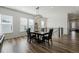 Well-lit dining room with hardwood floors and a modern light fixture ready for entertaining at 7169 Canyon Sky Trl, Castle Pines, CO 80108