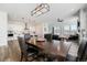 Open-concept dining area with hardwood floors and a modern light fixture next to a state-of-the-art kitchen at 7169 Canyon Sky Trl, Castle Pines, CO 80108
