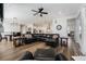 Open living room with hardwood floors, modern furniture, and a view of the dining area and kitchen at 7169 Canyon Sky Trl, Castle Pines, CO 80108