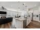 Spacious open concept layout with a kitchen island, stainless steel appliances, and a living room with fireplace at 7169 Canyon Sky Trl, Castle Pines, CO 80108