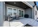 Covered patio with outdoor seating, a grill, and a view of the backyard and the neighborhood at 7169 Canyon Sky Trl, Castle Pines, CO 80108