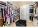 Spacious walk-in closet featuring custom shelving, ample storage space, and a center ottoman at 7169 Canyon Sky Trl, Castle Pines, CO 80108