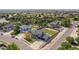 Aerial view of a home with a large backyard, well-manicured lawn, and a three car garage at 504 Branding Iron Ct, Brighton, CO 80601