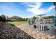 Spacious backyard with a stone patio, dining sets, plush landscaping, and a lush green lawn at 504 Branding Iron Ct, Brighton, CO 80601