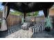 Relaxing backyard gazebo with comfortable seating, mature landscaping, and privacy fence for enjoyment at 504 Branding Iron Ct, Brighton, CO 80601