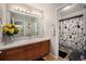 Traditional bathroom features a spacious vanity, floral accents, and walk-in shower with decorative curtain at 504 Branding Iron Ct, Brighton, CO 80601