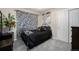 Cozy bedroom features unique zebra print curtains, rod iron bed frame, and plush gray carpeting at 504 Branding Iron Ct, Brighton, CO 80601