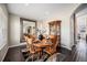 Formal dining room featuring a large wooden table, hardwood flooring, and sophisticated decor at 504 Branding Iron Ct, Brighton, CO 80601