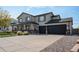 Inviting two-story home with a spacious driveway, front porch, and a two-car garage, perfect for comfortable living at 504 Branding Iron Ct, Brighton, CO 80601