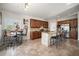 Well-lit kitchen features custom cabinets, granite countertops and an island with seating at 504 Branding Iron Ct, Brighton, CO 80601