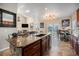 Open concept kitchen with granite countertops, island and stainless appliances open to Gathering room at 504 Branding Iron Ct, Brighton, CO 80601