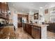This kitchen features granite countertops, stainless appliances, an island, and ceramic tile floors at 504 Branding Iron Ct, Brighton, CO 80601