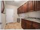 Laundry room offers granite countertops, ample cabinet storage, and convenient access to the home at 504 Branding Iron Ct, Brighton, CO 80601