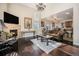 Open living room with fireplace, hardwood floors, a high ceiling, and seamless flow to the kitchen at 504 Branding Iron Ct, Brighton, CO 80601
