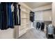 Well-organized walk-in closet with ample shelving and hanging space for clothing and accessories at 504 Branding Iron Ct, Brighton, CO 80601