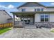 Home features a covered porch overlooking a stamped concrete patio and manicured lawn at 690 Avena Dr, Elizabeth, CO 80107