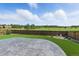 Large, grassy backyard with stone patio and wood fence offering a private outdoor space at 690 Avena Dr, Elizabeth, CO 80107