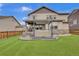 Landscaped backyard featuring a hot tub with a gazebo and an outdoor living area, perfect for relaxation and entertainment at 690 Avena Dr, Elizabeth, CO 80107