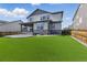 Spacious backyard with a manicured lawn, stamped concrete patio, and privacy fence at 690 Avena Dr, Elizabeth, CO 80107