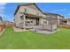 A well-maintained backyard with artificial turf, a hot tub under a gazebo, and outdoor seating for ultimate relaxation at 690 Avena Dr, Elizabeth, CO 80107