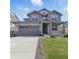 Charming two-story home features a landscaped front yard, inviting porch, and attached two-car garage at 690 Avena Dr, Elizabeth, CO 80107