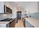 Modern kitchen with stainless steel appliances and light gray cabinets at 17361 E Mansfield Ave # 531R, Aurora, CO 80013