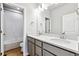 Bathroom featuring double sinks, quartz countertop, updated fixtures, and tile flooring at 2548 Wesley Ln, Lafayette, CO 80026