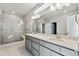 Modern bathroom featuring dual vanity, quartz counters and a frameless glass shower at 2548 Wesley Ln, Lafayette, CO 80026