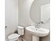 Clean powder room featuring modern fixtures, pedestal sink, and ample lighting at 2548 Wesley Ln, Lafayette, CO 80026