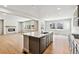 Modern open kitchen with stainless appliances, island, and hardwood floors at 2548 Wesley Ln, Lafayette, CO 80026