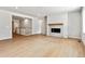 Spacious living room with fireplace, light wood floors, and neutral paint at 2548 Wesley Ln, Lafayette, CO 80026