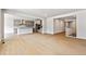 Open-concept living space connecting to modern kitchen and staircase at 2548 Wesley Ln, Lafayette, CO 80026