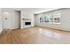 Bright living room features fireplace, hardwood floors, and large windows at 2548 Wesley Ln, Lafayette, CO 80026