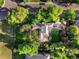 Aerial view of a home with lush green backyard, patio, and surrounding mature trees at 4600 E 3Rd Ave, Denver, CO 80220