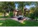 Backyard with a stone patio, seating, and a well-manicured lawn at 4600 E 3Rd Ave, Denver, CO 80220