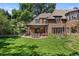 Expansive backyard featuring a covered patio and lush lawn, perfect for outdoor entertaining and relaxation at 4600 E 3Rd Ave, Denver, CO 80220