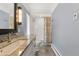 Bathroom features a white vanity, granite countertop, and a shower with patterned curtain at 4600 E 3Rd Ave, Denver, CO 80220