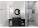 Bathroom with a round mirror, granite counters, and a glass enclosed shower at 4600 E 3Rd Ave, Denver, CO 80220