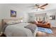 Bedroom with a ceiling fan, wood floors, a patterned rug, and a comfortable seating area at 4600 E 3Rd Ave, Denver, CO 80220