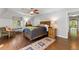 Bedroom with hardwood floors, a ceiling fan, and a large bed with a wood frame at 4600 E 3Rd Ave, Denver, CO 80220